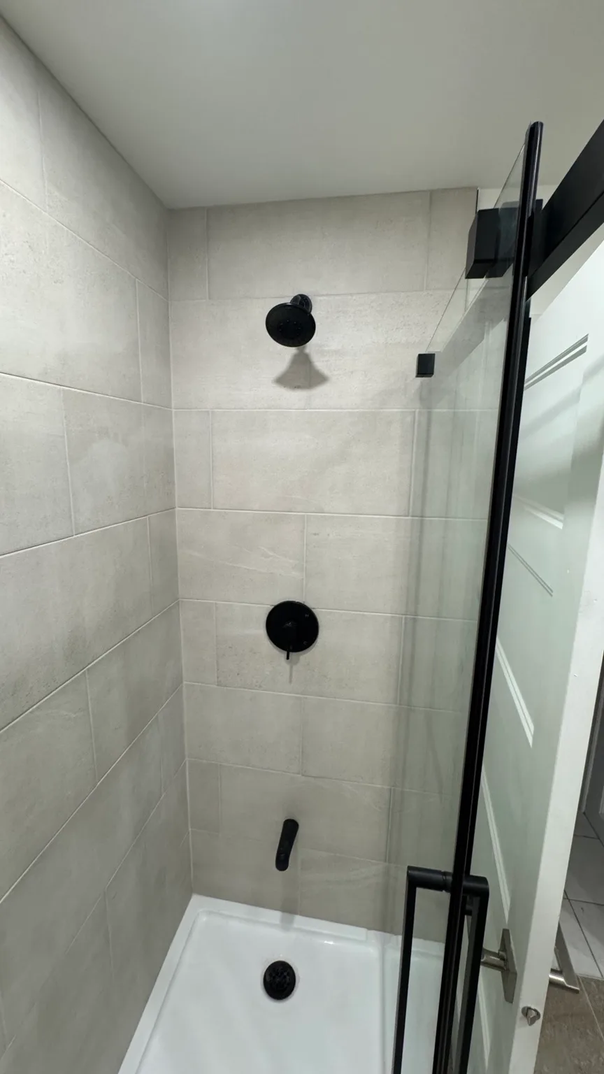Laundry area integrated into the renovated bathroom.