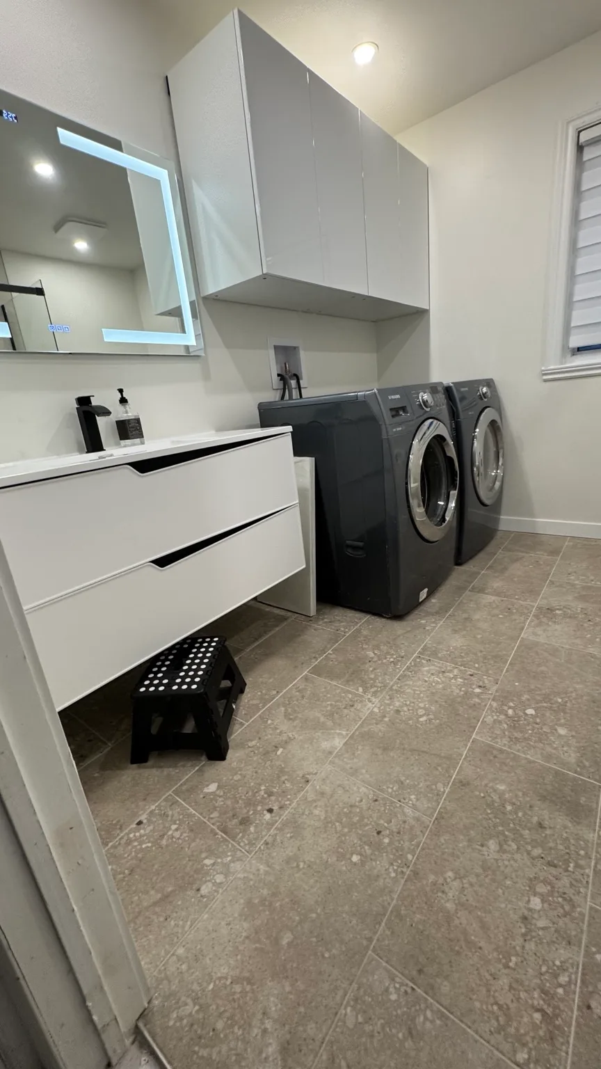 View of the laundry area and storage after the renovation.