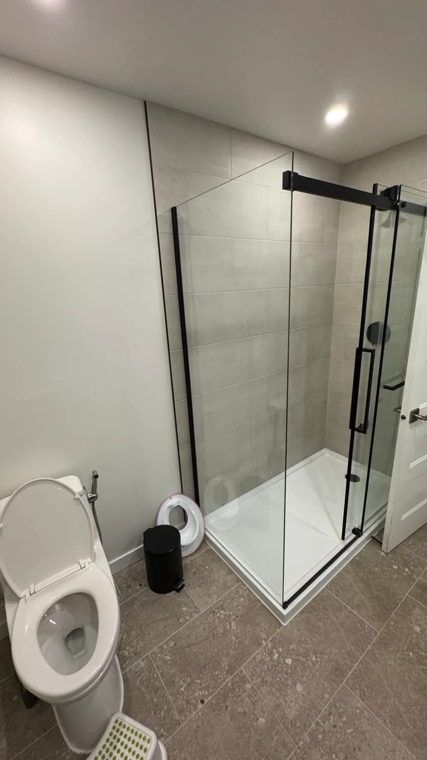 Overall view of the renovated bathroom and laundry room after completion.