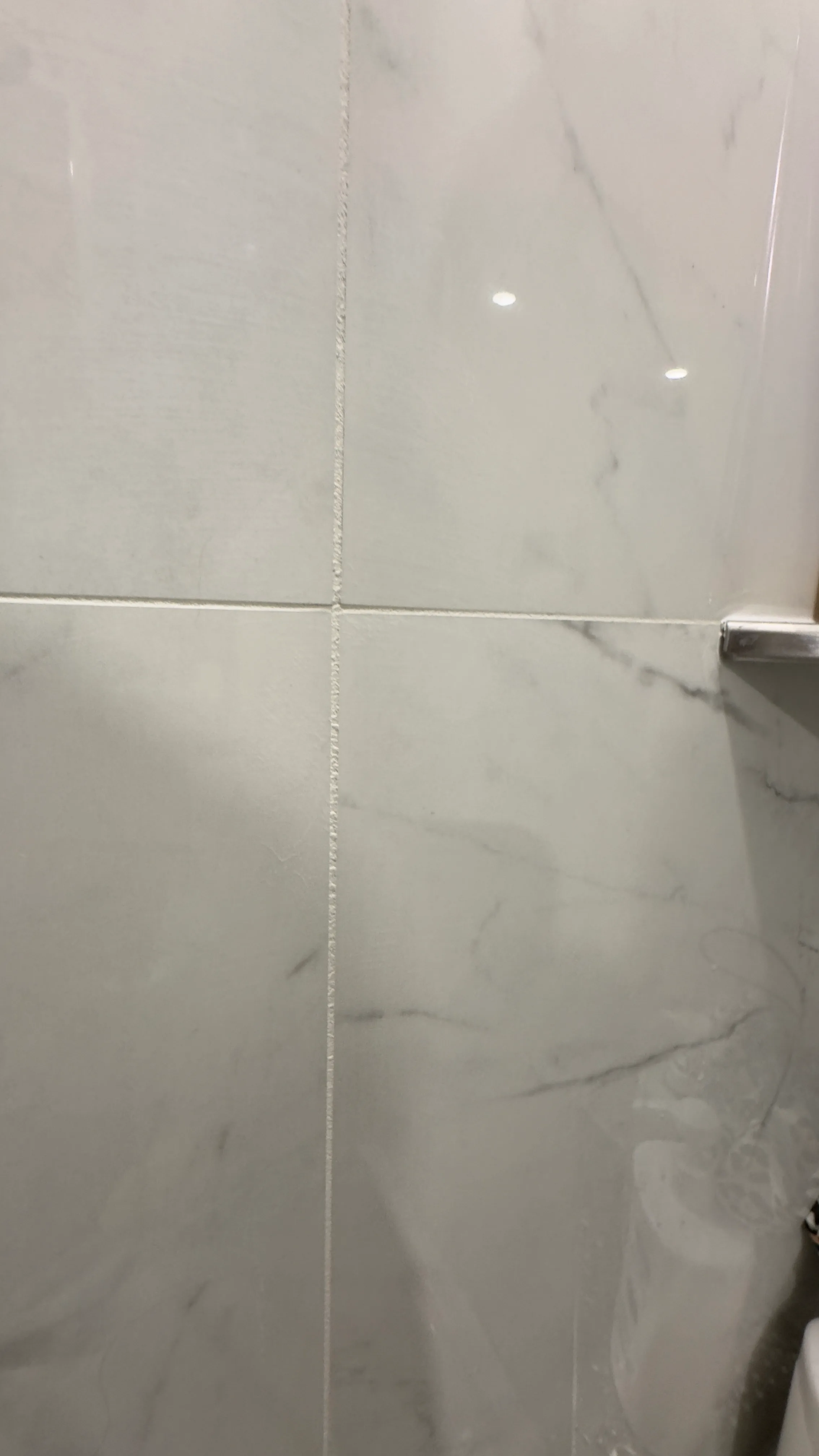 Epoxy grout detail between large-format porcelain tiles.