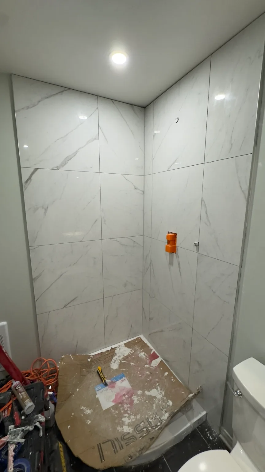 Large-format porcelain shower before the glass doors were installed.